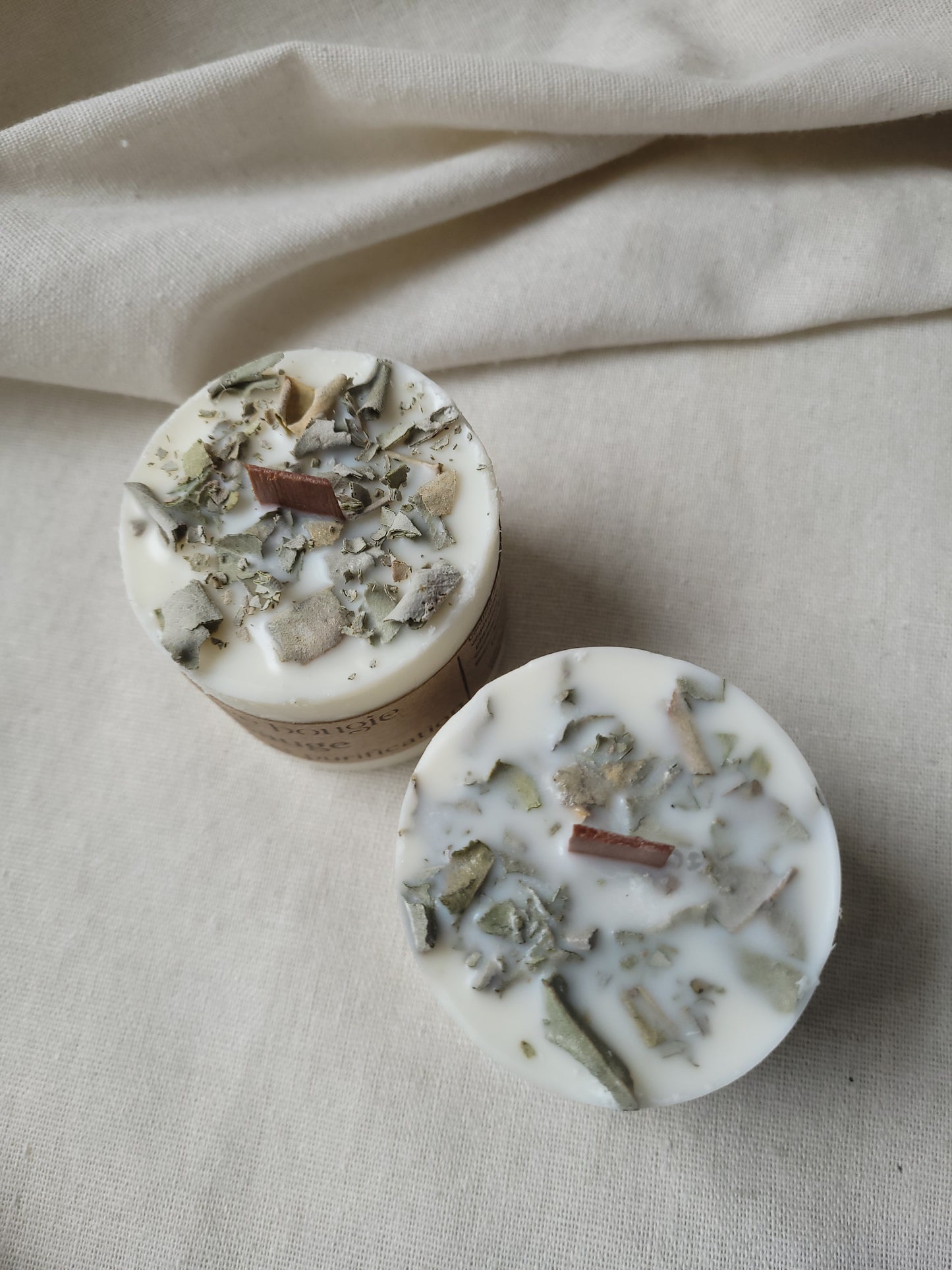 Présentation des ingrédients de la bougie, incluant la cire de soja et les parfums de Grasse, soulignant l’aspect artisanal et écologique du produit.